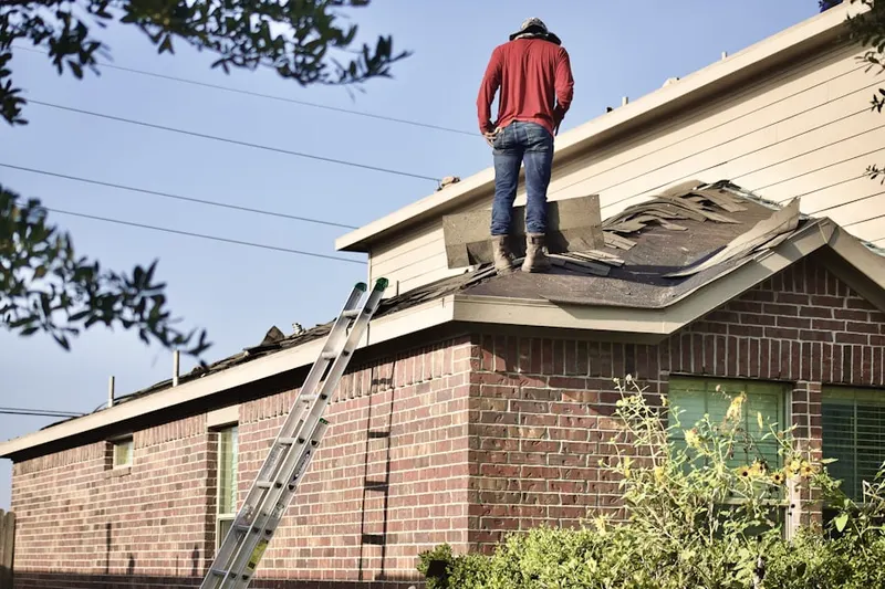 Professional roofer working on a residential roof in Blandburg